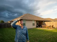 Homeowner checking roof before storm